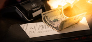 Restaurantrechnung mit einem Fünf-Dollar-Schein als Trinkgeld